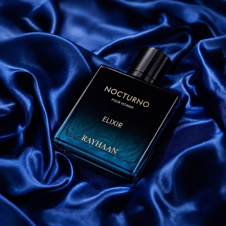 Scent Sphere Nocturno Elixir Pour Homme fragrance bottle with golden amber notes on dark blue satin.