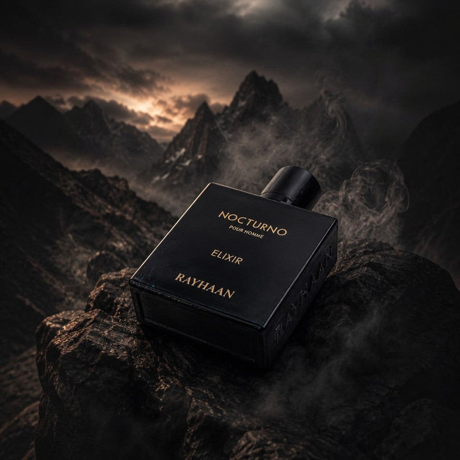 Scent Sphere Nocturno Elixir Pour Homme fragrance bottle with golden amber notes, presented on a rocky outcrop.